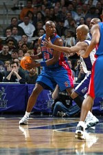 Clifford Robinson Detroit Pistons looks to pass v defense by Sam - 2002 Photo
