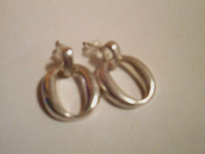 Silver tone small hoop like earrings
