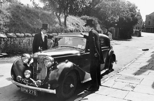 Eton School pupils dinner jackets bowler hats leaning car cir- 1955 Old Photo