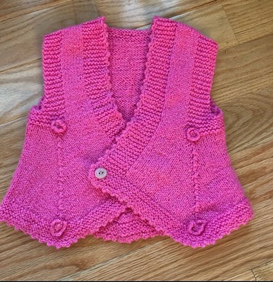 Pink knitted vest for girls approximately 3 to 5  years old.