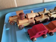 Small toy train sets, magnetic connections, wood color, one set multi-colored
