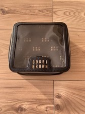 Bobbi Brown Black Faux Leather Makeup Bag with Gold Trim and Zip-Up Closure.