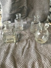 Set of 4 assorted clear glass bottles