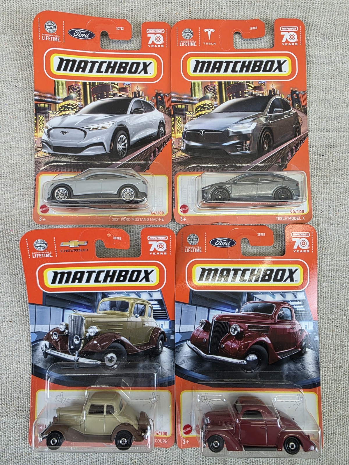 Lot Of 4 Matchbox Tesla Ford Chevy NIB