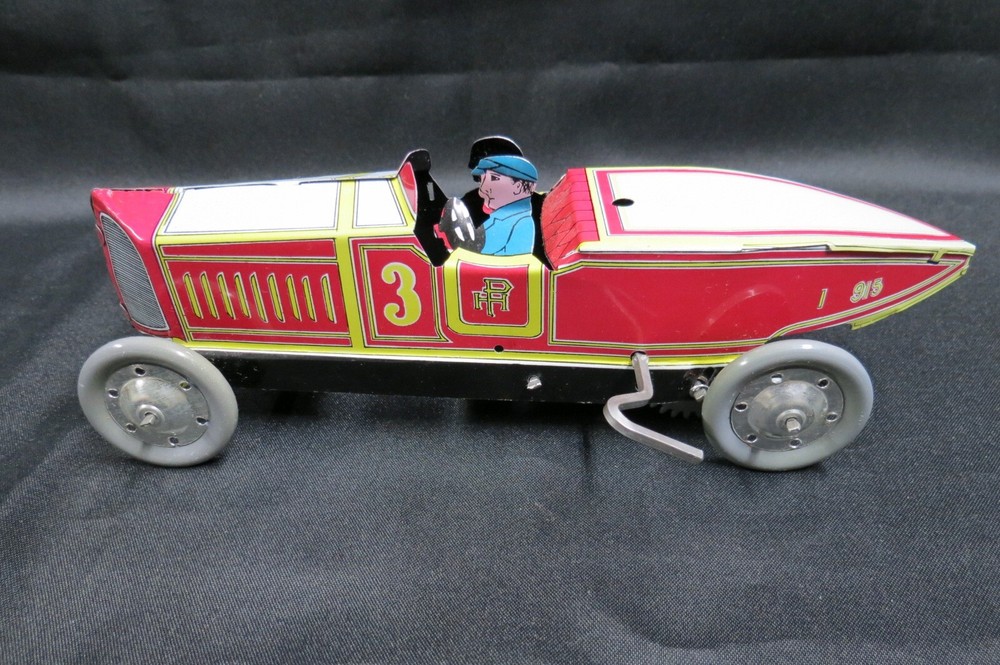 Vintage tin wind-up race car toy in excellent condition