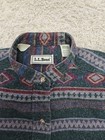 Vintage LL Bean men’s L gray green flannel with red, blue, and beige Aztec-style stripes and white LL Bean logo on collar.