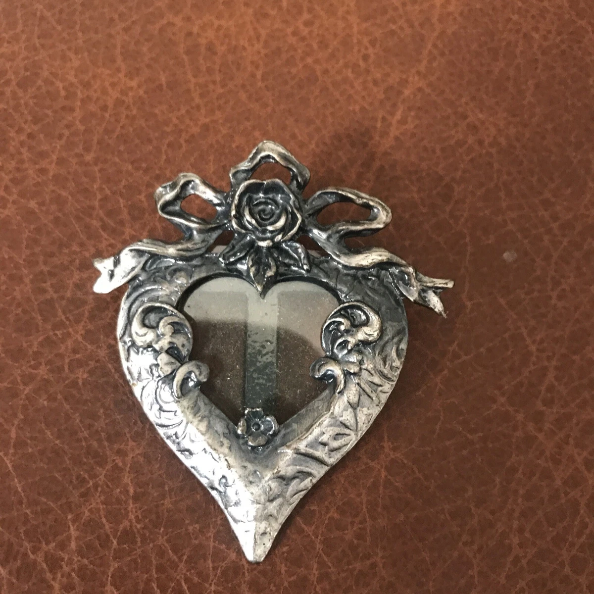 Picture frame brooch. Silver pewter tone in shape of heart w roses and ribbons