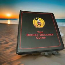 DISNEY'S **THE DISNEY DECADES** 55 COLOURED COINS & TRADING CARD SET IN ALBUM