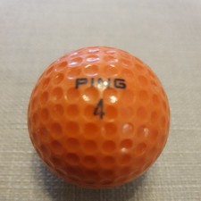 VINTAGE 1970S ORANGE AND WHITE PING GOLF BALL