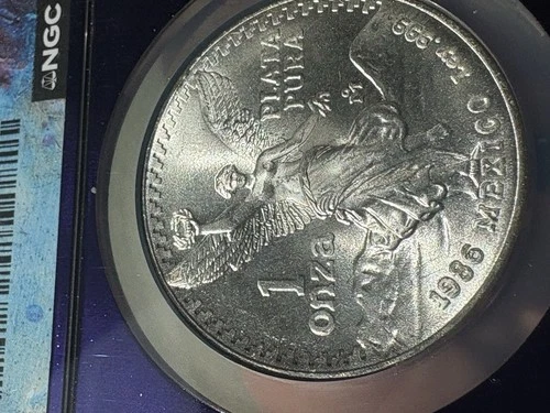 1986 Mo Mexico 1 Silver Onza, NGC Graded: MS 66 TRADER Bea purple Core  