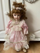 Porcelain doll in pink dress