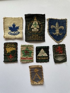 Eight 1955 Canada 8th World Scouts Jamboree Badges.