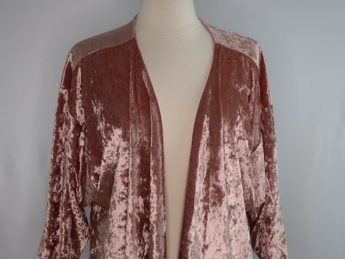 Rose gold pink velvet cover up jacket with long sleeves and open front displayed on a mannequin.