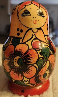 A set of five hand-painted wooden Matryoshka nesting dolls, tallest 5.5 inches.