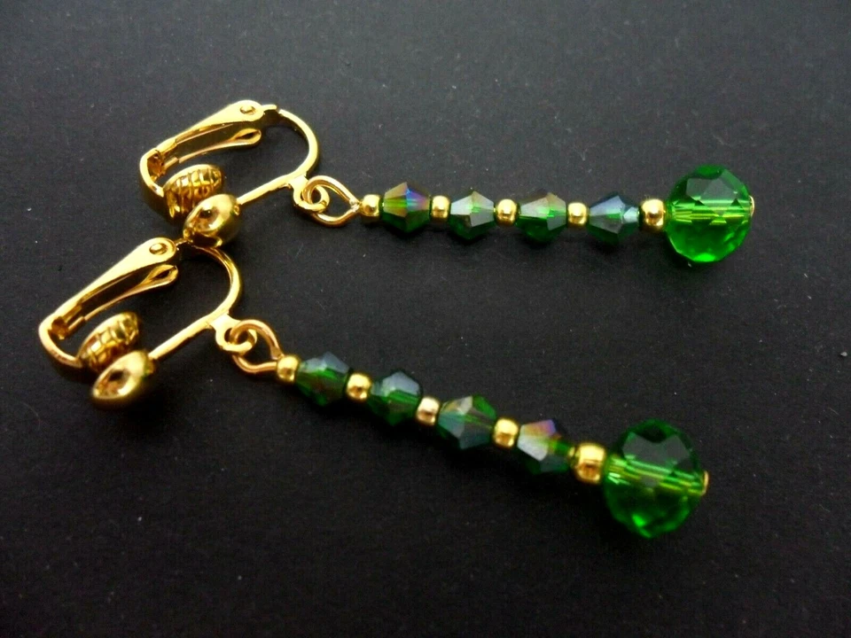 A PAIR OF DANGLY GREEN CRYSTAL BEAD GOLD PLATED CLIP ON EARRINGS. NEW. - Image 1 of 1