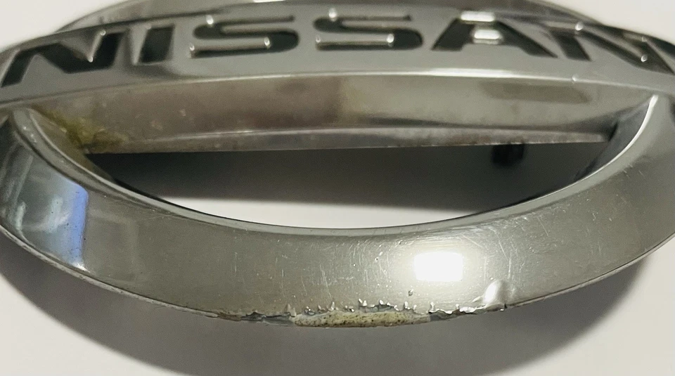 2001-2004 Nissan Xterra Front Emblem OEM  - Image 2 of 4