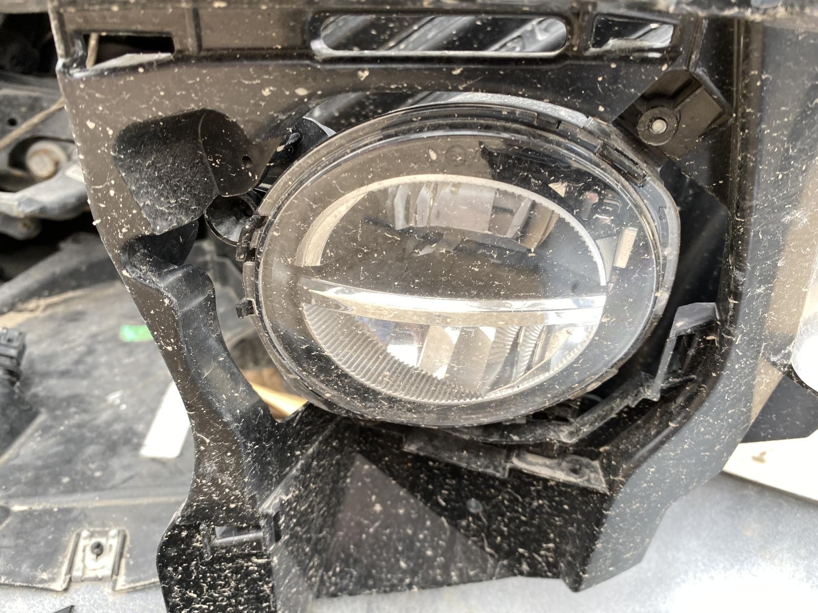 Black used left door mirror with oval clear lens, wiring, and mounting point on a worn, dirty BMW 430I dashboard.