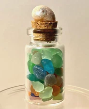 Mini bottle filled with tiny, multi-color sea glass with sparkling shell cork 