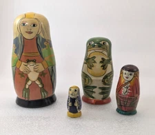 4 piece Authentic Model Nesting dolls; woman, frog, girl, girl/cat