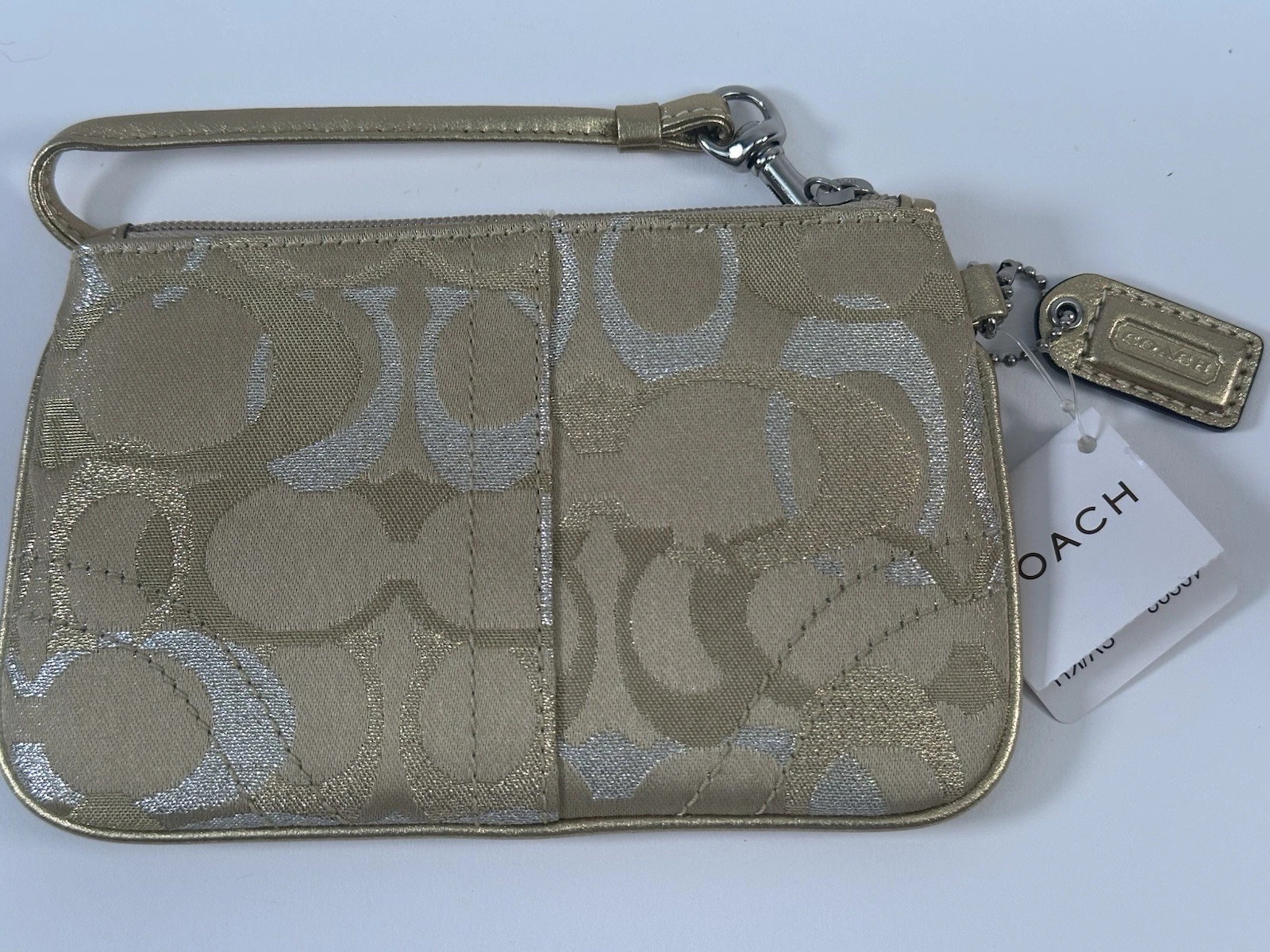Mini pochette Coach da polso oro metallizzato e argento con logo monogramma e cerniera