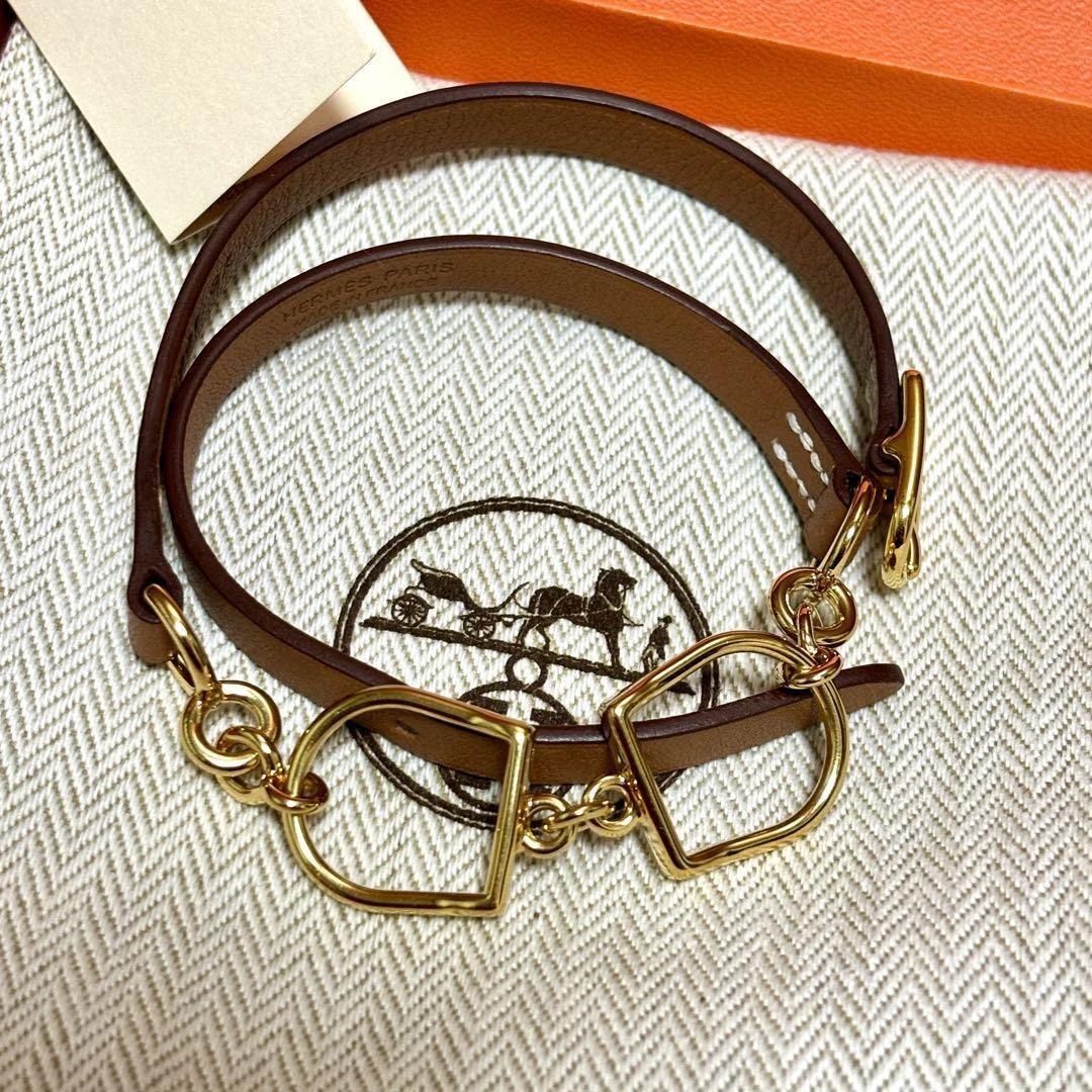 HERMÈS Bracciale HERMES Etrier doppio tour avvolgente pelle marrone placcato oro morso di cavallo con scatola