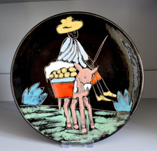 Tunisian pottery wall plate, black glaze with colourful hand drawn figure