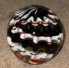 CONTROLLED BUBBLE GLASS PAPERWEIGHT RED & WHITE & BLACK SWIRL SPI HOME STICKER