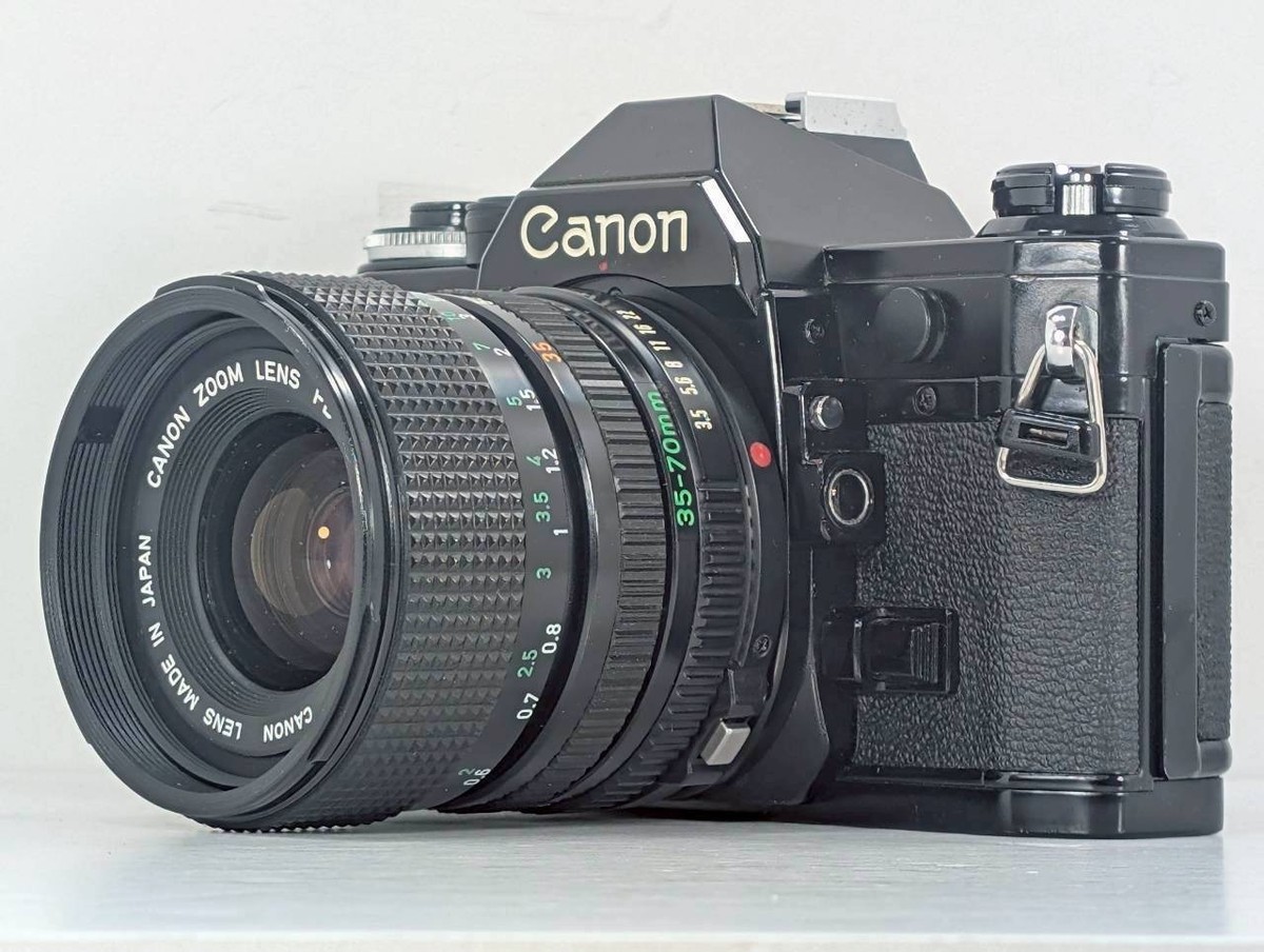 フィルムカメラ Canon AE-1 Black New FD 35-70mm f/4 Lens Exc+5 READ] Canon AE-1 SLR 35mm Film Camera Black + NFD 35-70mm f