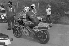 Steve Parrish sits on his running Suzuki RG500 in the paddock area- Old Photo
