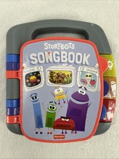 Fisher-Price STORYBOTS Songbook Lights Music Education Space Dinosaur Body READ