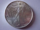 4 AMERICAN SILVER EAGLES LOT. 1990, 1991, 2022, and 2025. BONUS 2004/2021 ALBUM.
