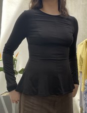 Black h&m peplum long-sleeve top, size m, perfect for work or casual.