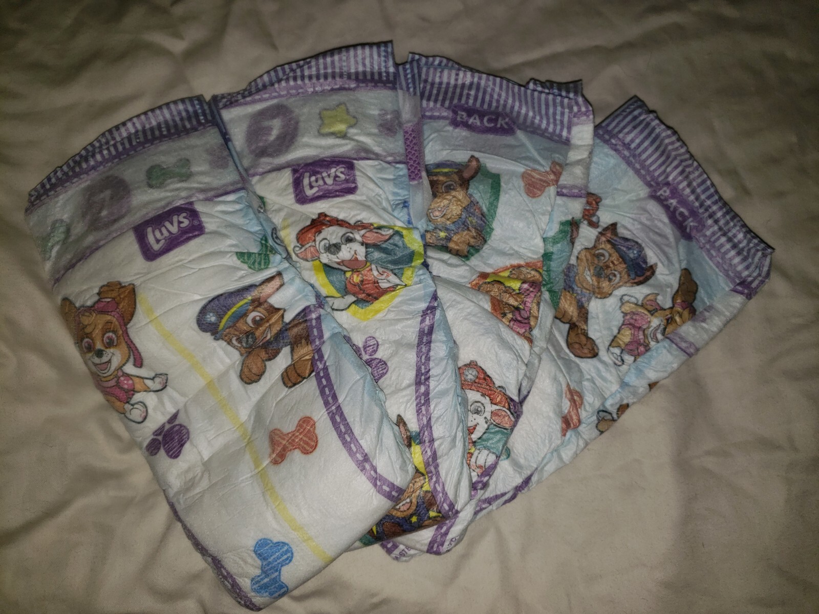 (4) Samples of Luvz Paw Patrol Size 7 Diapers for Girls or Boys 41 LBS+