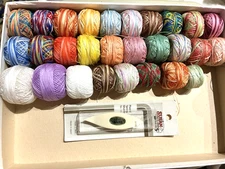Lot with 28  balls of vintage tatting threads & a shuttle many variegated