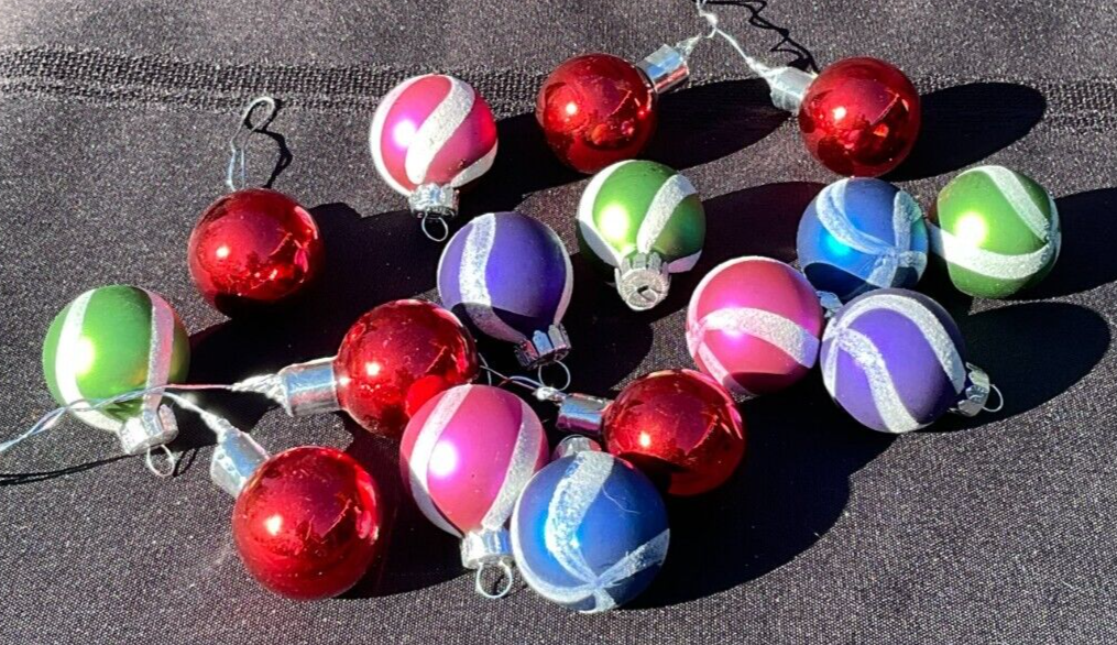 Lot of 16 round Christmas balls with multicolor horizontal stripes in red, green, silver, and pink, tied with black wire.