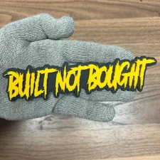 Built Not Bought Grill Badge Yellow Emblem Angry Agressive Racing Black