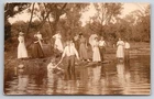 Man Getting Baptized? People Fishing Fish on Pole c1910 Real Photo RPPC