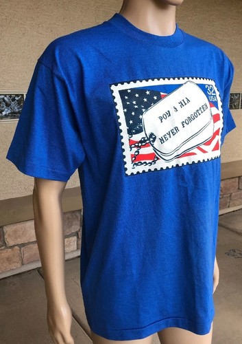 Blue EUC vintage 1995 T-shirt with red, white, and blue POW MIA Never Forgotten stamp and American flag on chest.