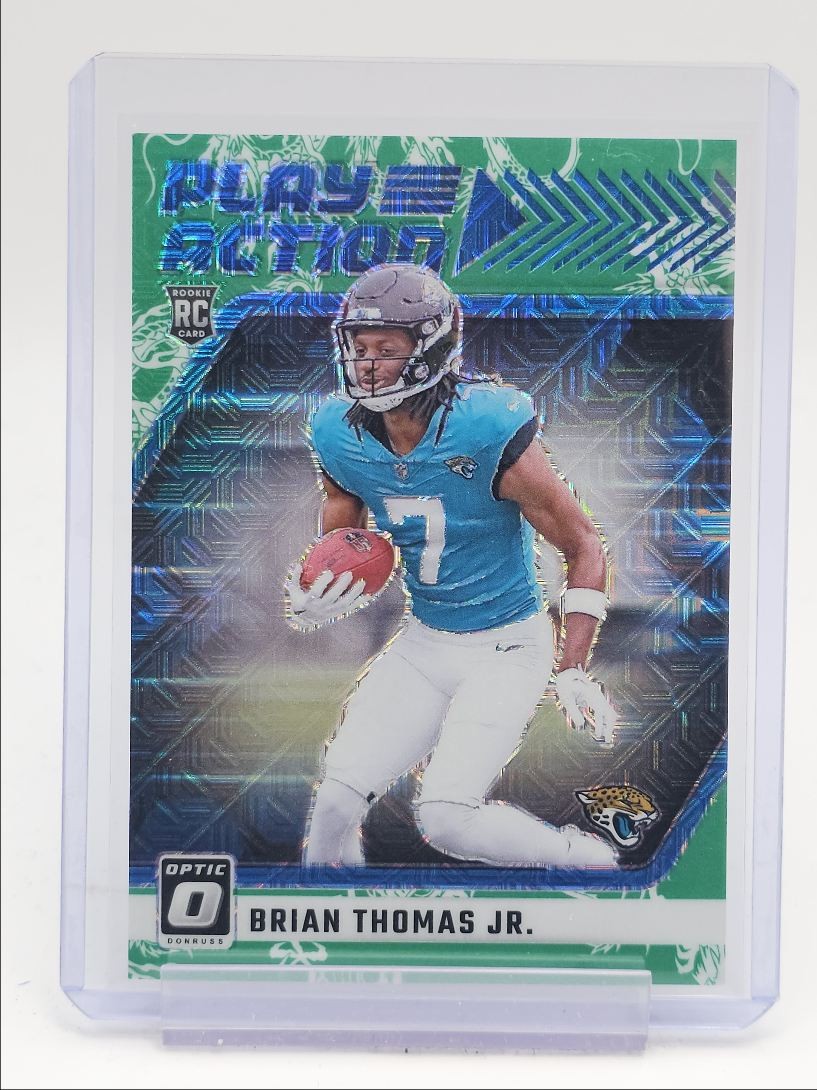 BRIAN THOMAS JR. 2024 DONRUSS OPTIC PLAY ACTION ROOKIE DRAGON RC /24 Q5692