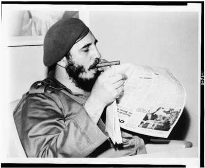 Photo:Fidel Castro catches up on the news 1961