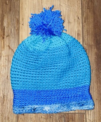 Homemade Different Colors Of Blue Crocheted Hat With A Pom-Pom On Top