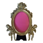 Vintage style oval gilded gold cherub putti photograph picture frame.