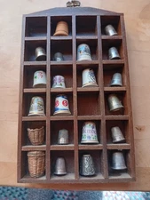 LOT OF 21 THIMBLES & HOLDERS INCLUDES WOODEN DISPLAY SHELF. 852