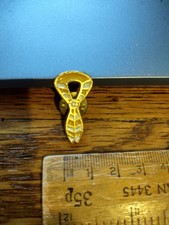 Yellow & white necker pin badge, used