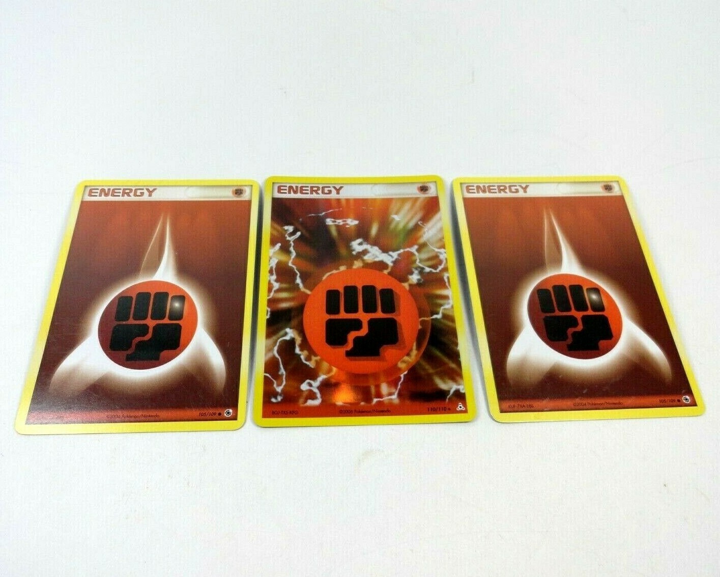 Fighting Energy 110/110 Holo 2006 Pokemon Card with two 105/109 cards 2004