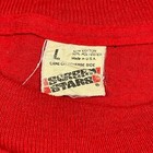 Red vintage 80s tech shirt with white printed text “80s True Stars,” size L, single stitch across the chest.