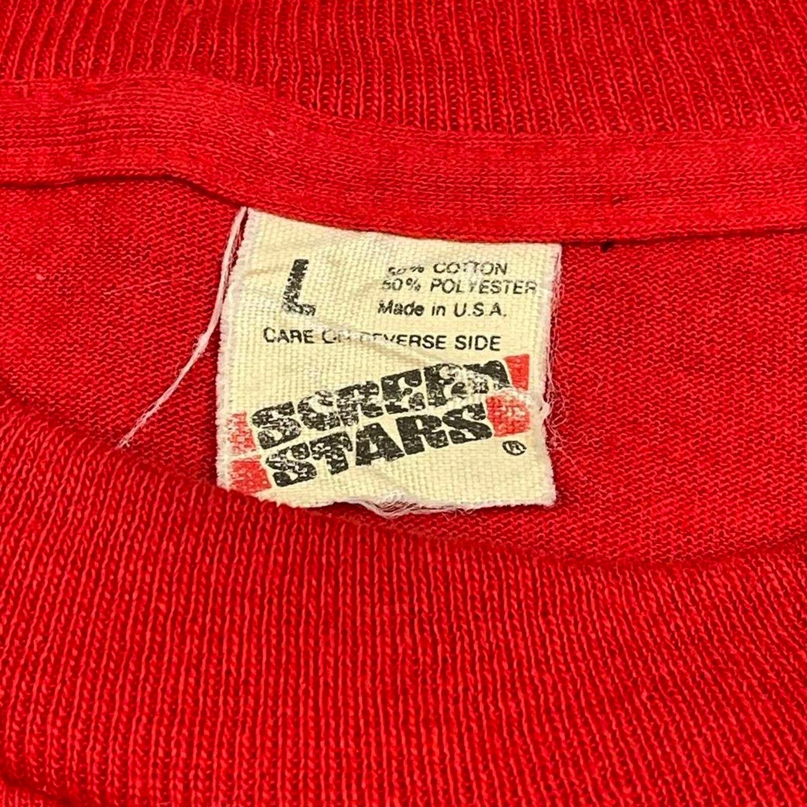 Red vintage 80s tech shirt with white printed text “80s True Stars,” size L, single stitch across the chest.