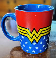 DC Comics Wonder Woman coffee mug featuring her classic gold "W" insignia. 12oz