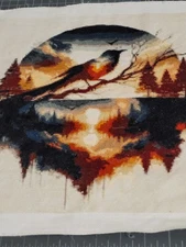 finished cross stitch bird on a lake unframed