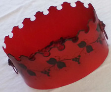 red metal basket with grapevine motif and Lio...